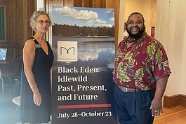 Holland Museum Executive Director Ricki Levine and Chris CJ Kingdom-Grier in front of the exhibit.
