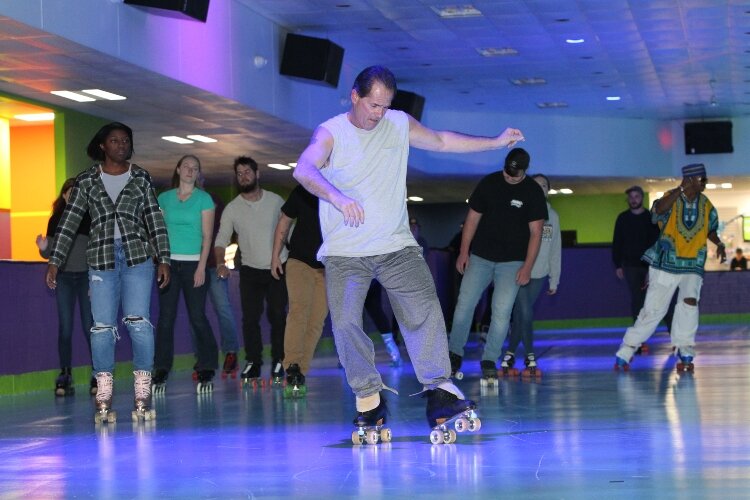 Mark Dicocco, of Allendale, center, shows off his skate moves while roller skating at RollXscape Skating Center’s grand opening in Holland Township, Nov. 4. 