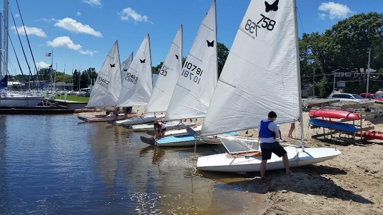 A member of the Muskegon Junior Sailing Program's Butterfly Fleet prepares to go out on the water.