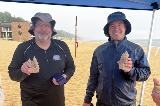 The winners of this year's sand sculpture contest received sandcastle trophies. 