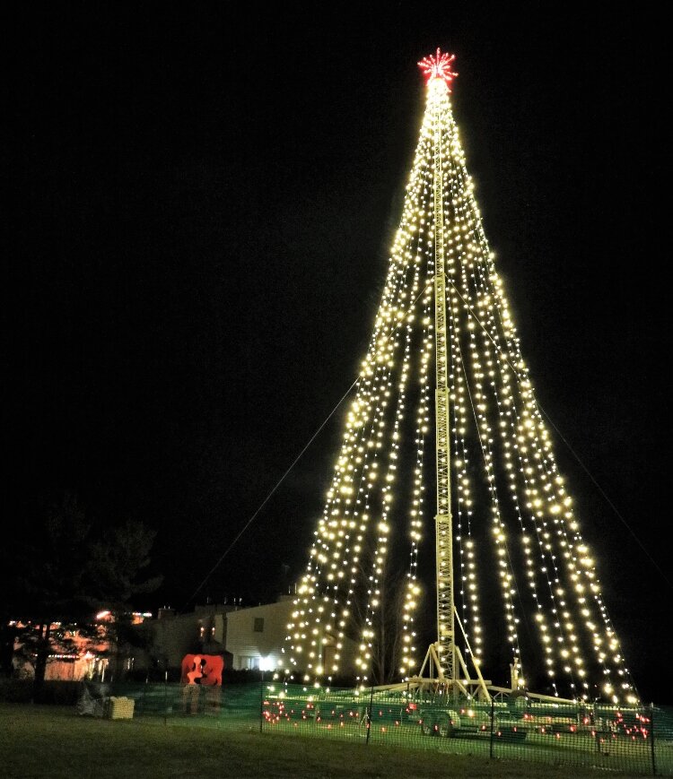 An 80-foot Christmas tree tower brightens up the sky over downtown Saugatuck.
