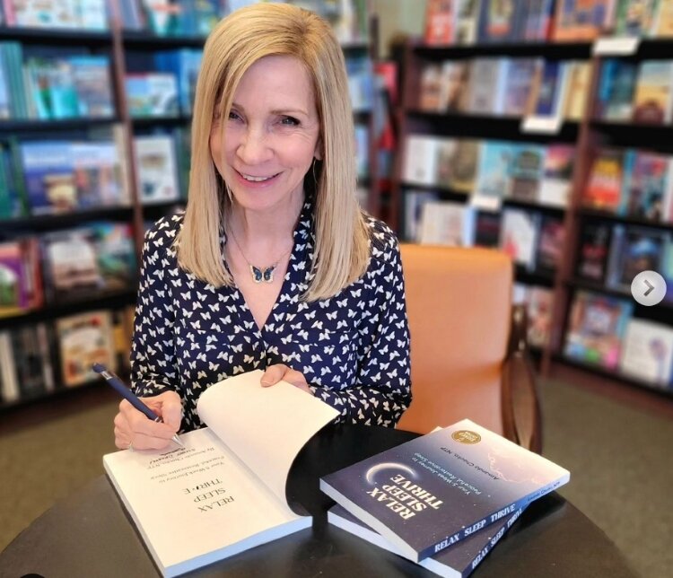 Amanda Chocko signs her book, “Relax Sleep Thrive: Your 5-Week Journey to Peaceful, Restorative Sleep."