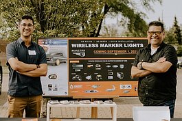 Luciano Hernandez V and his dad, Luciano Hernandez IV, display their product, Spirit Fire Lights, at the SURGE Celebration. 