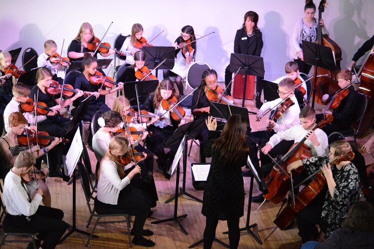 The WMS’s Debut Strings string orchestra program performs in 2019. The proposed Tune Up program is also a string orchestra program, slated to begin in 2022 in Muskegon Public Schools, in collaboration with their IMPACT after-school program.