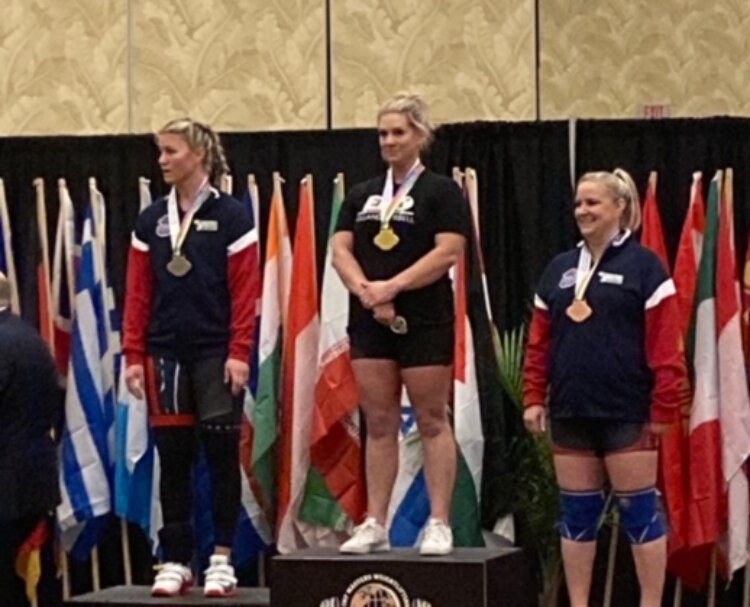 Zeeland teacher Traci Gonzales brought home the gold from the International Weightlifting Federation championships.