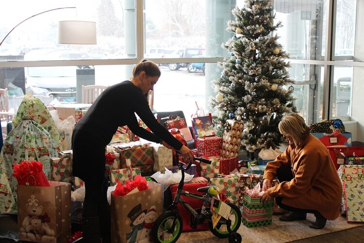 Trendway employees wrap Christmas gifts that will be given to foster children.