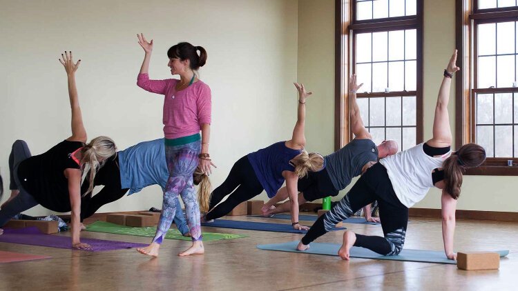 This prepandemic photo shows yoga instructor Julia Fisher leading a yoga class. She’s helping people find connection through yoga at several lakeshore studios.