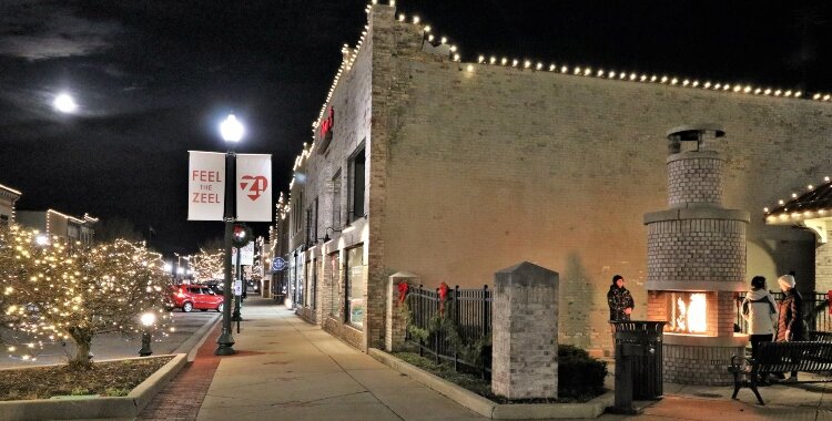 A tour of downtown Zeeland's holiday decorations begins alongside the fireplace at Heritage Square.