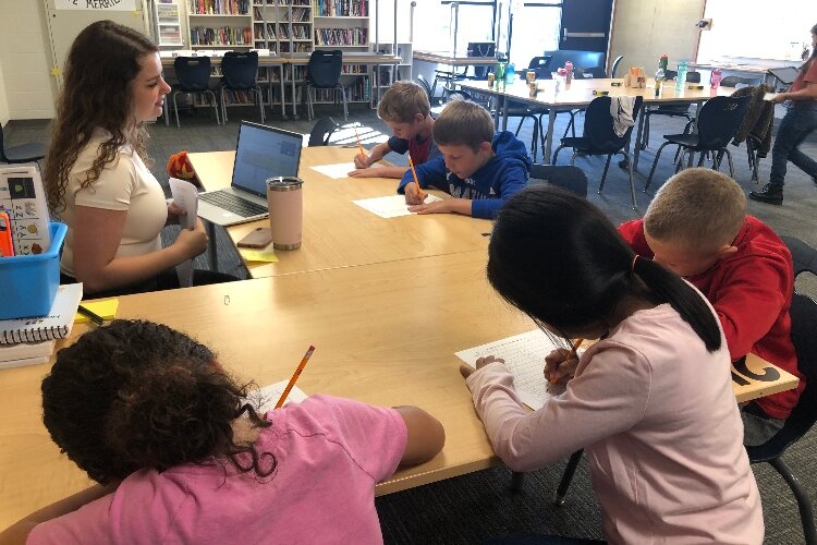 A teacher works with students at Zeeland Public Schools.