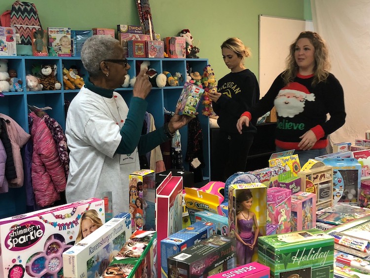 Volunteers set up the annual Holiday Store where clients can shop for what they need.