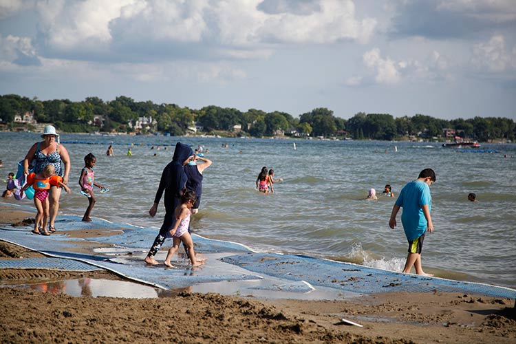 Beachgoers in a variety of swimwear. Photo by Imad Hassan.