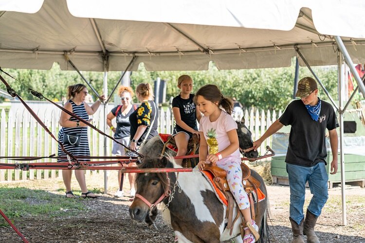 A young person gets in the rodeo spirit at Country to the Core.