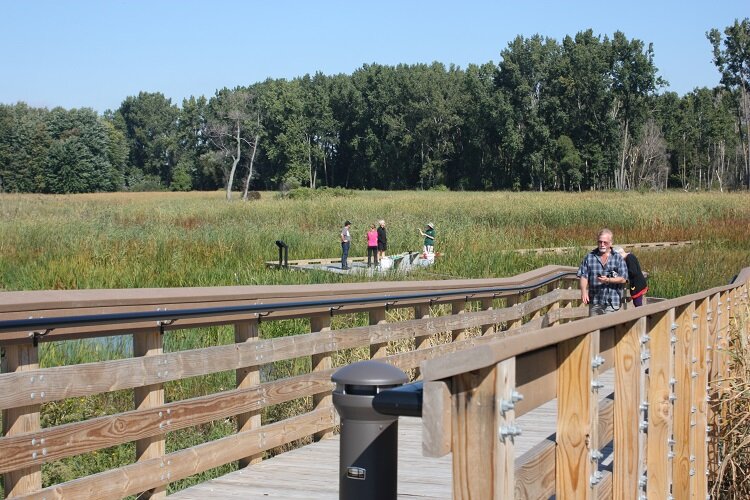 Parkgoers enjoy a boardwalk at Lake St. Clair Metropark.