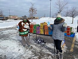 Girl Scouts showcase the varieties of cookies available for purchase.