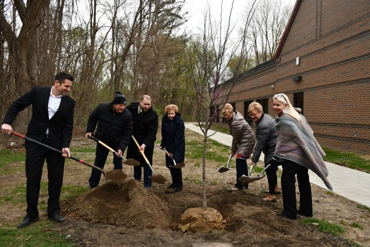 Mayor Michael Taylor (L to R), Councilman Henry Yanez, Councilman Michael Radtke, Councilwoman Deanna Koski, Councilwoman Barbara Ziarko, Councilwoman Maria Schmidt and Mayor Pro Tem Liz Sierawski plant a tree at the Sterling Heights Senior Center.