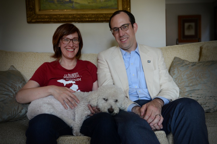 Elizabeth and Jeff Dunlap pose for a photo with their dog Mickey inside their home on Fort Street in Dearborn. Photo by Jessica Strachan 