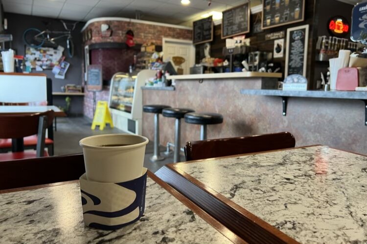 This small but mighty cafe on Dodge Park Road defines warm and cozy with its wood interiors, wall-mounted fireplace, and old school coffee counter.
