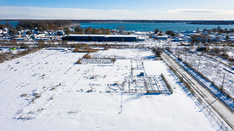 Mill Street redevelopment site in Ecorse with Detroit River in background.