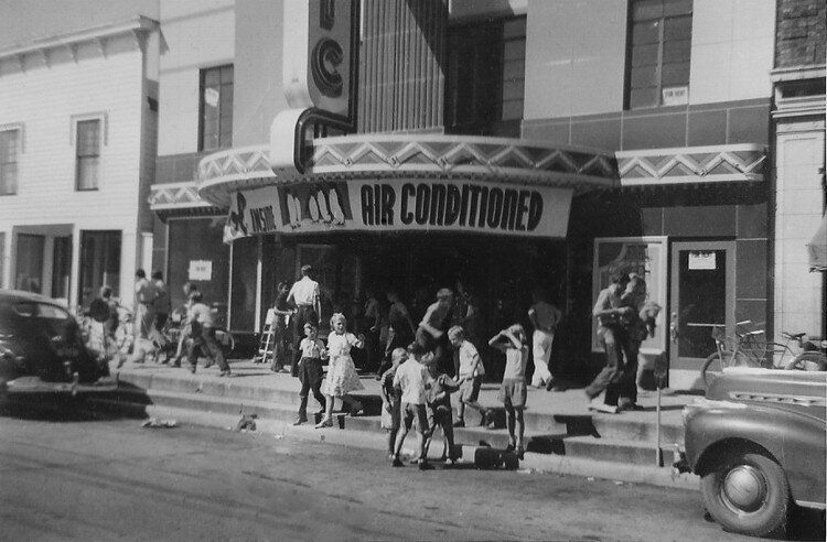 Children congregate outside of the air conditioned theater