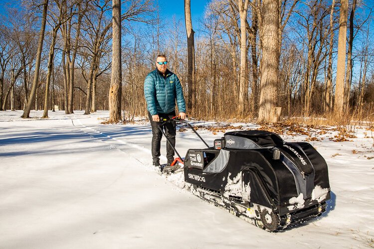 Jeremy Verbeke of CRAMBA and the National Ski Patrol with snow grooming equipment.