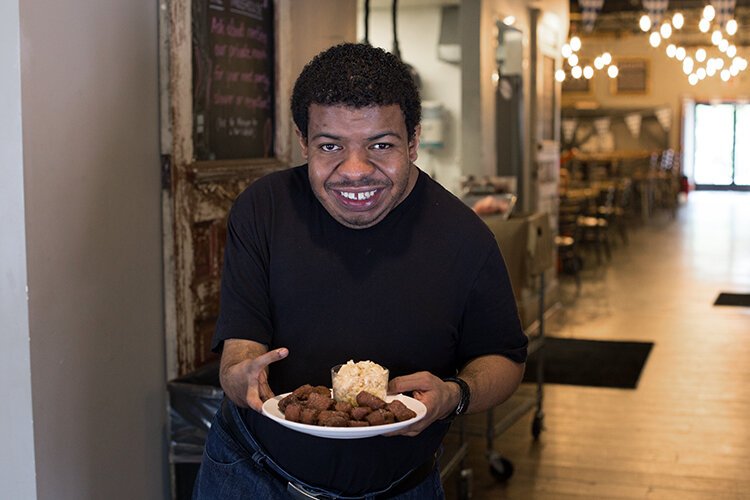 George Hamilton proudly shows off the pretzel bites he helps make at Homegrown Brewing Company.