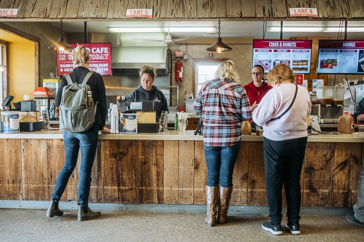 Customers buy cider and donuts at Blake's Orchard.