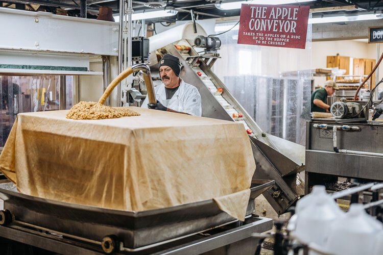 An employee makes cider at Blake's Orchard.