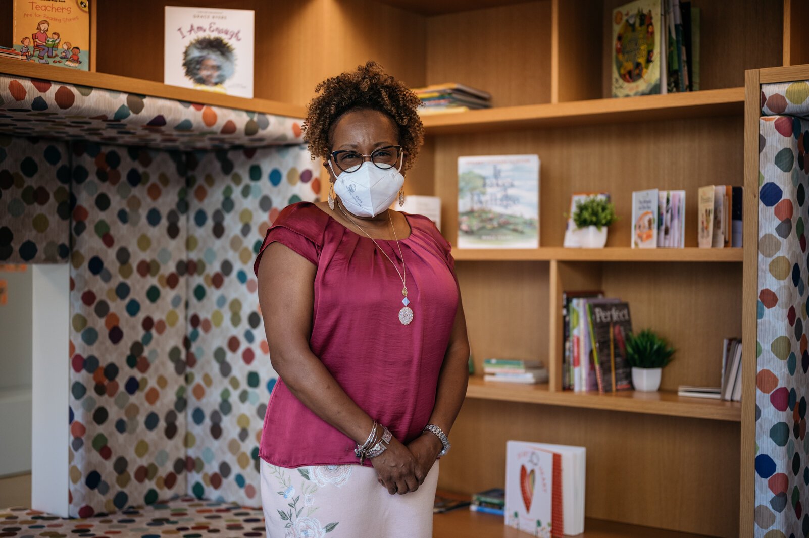 Principal Celina Byrd in the book nook. Intentionally designed spaces at the center, she says, ensure children, parents, staff, and the community all have a place. 