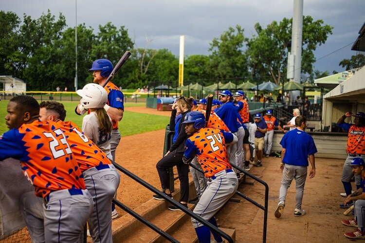 Diamond Hoppers players watch game from the dugouts.