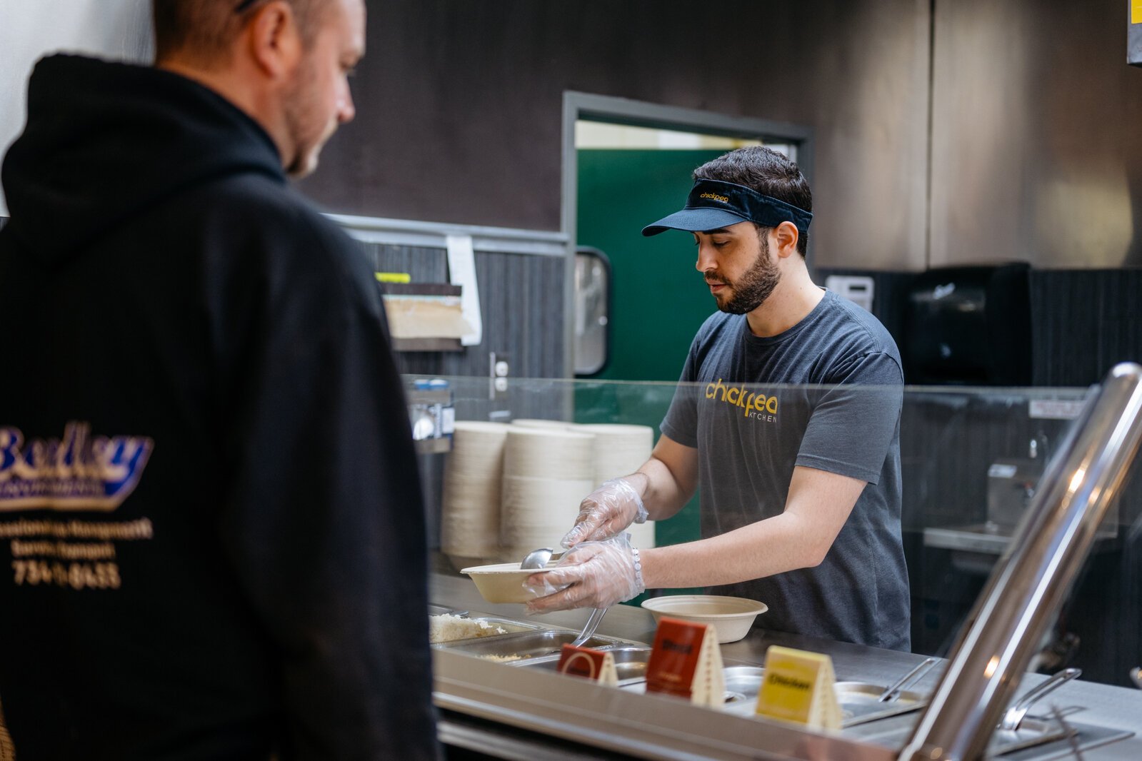 Nathan Kiriakoza serves customers at Chickpea Kitchen in Sterling Heights.