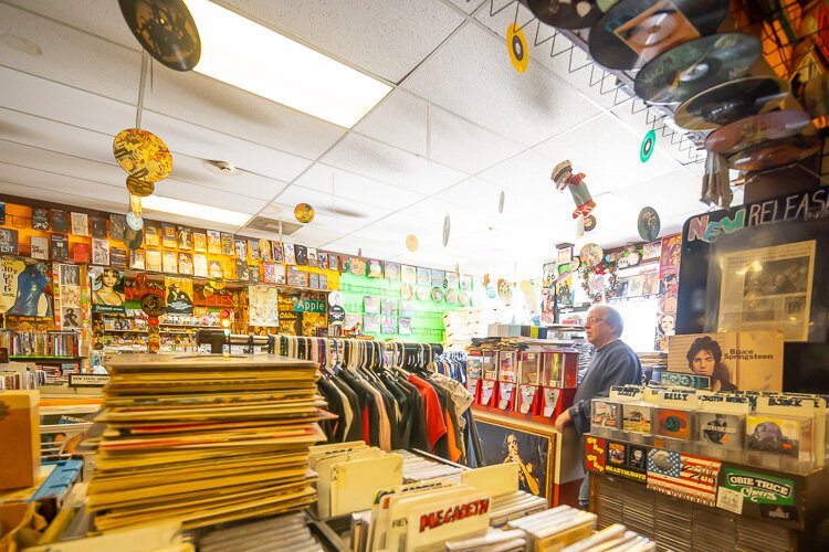 M&M co-owner Dan Ziega handles the register at his record store.