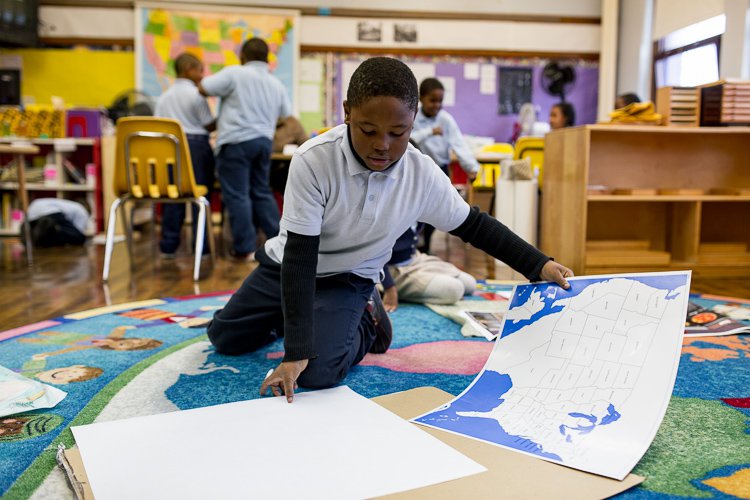 Detroit Montessori student Bryan Smith, 8, demonstrates how traced a classroom map to create his own, colorful map of the United States.