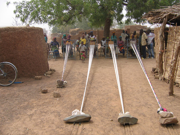 Images from Burkina Faso, where the women weave hundreds of meters of fabric on outdoor looms every year.