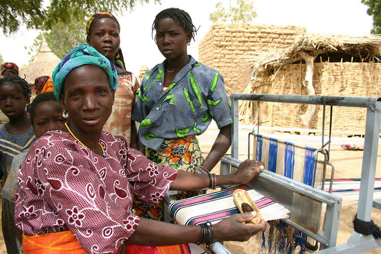 Images from Burkina Faso, where the women weave hundreds of meters of fabric on outdoor looms every year/