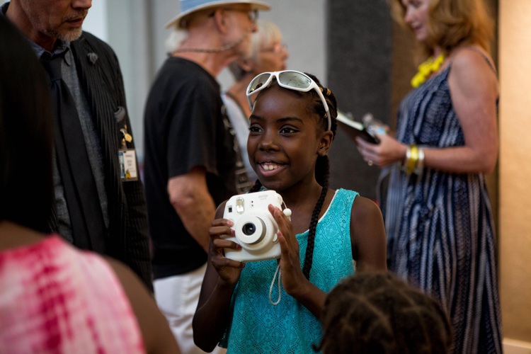 Destiny receiving her Fuji Instax camera from Art&Soul. Photo by Nick Hagen. 