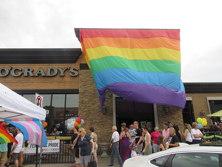 Pride flag hanging in the front of Rosie O'Grady's. Andrea Davis with another instructor at Bikram Yoga Ferndale, Photo by Micah Walker.