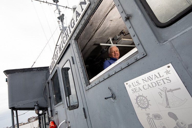 Captain Luke Clyburn looks out a window on the Pride of Michigan.