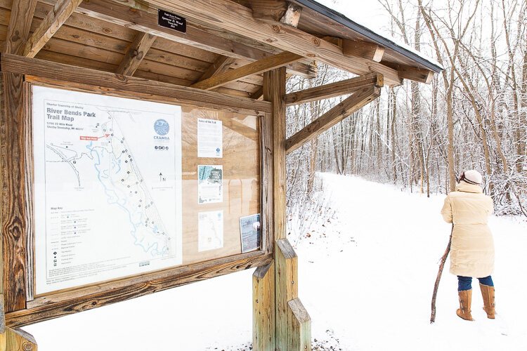 A hiker takes in the winter splendor at River Bends Park.