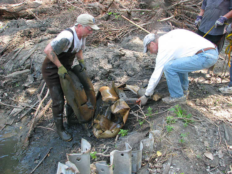 Volunteers remove debris from the Rouge River.