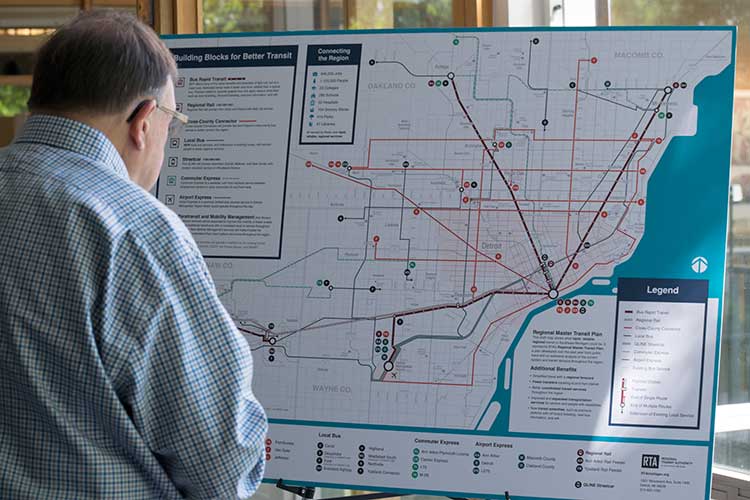 An attendee views the RTA's draft regional plan.