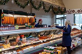 A customer orders from the meat deptartment at Srodek's.