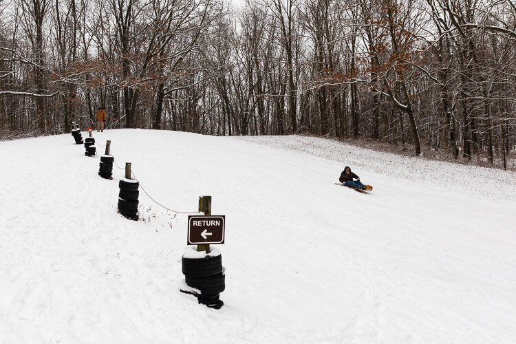 A sledder tries their luck at Stony Creek.