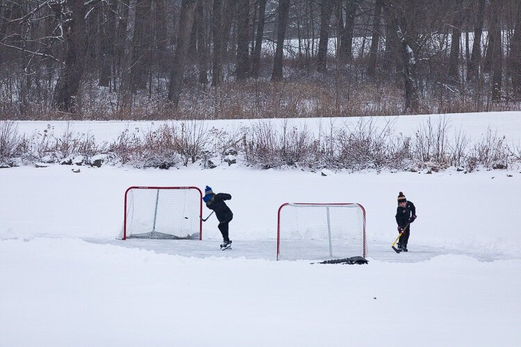 Two hockey players have some fun at Stony Creek.