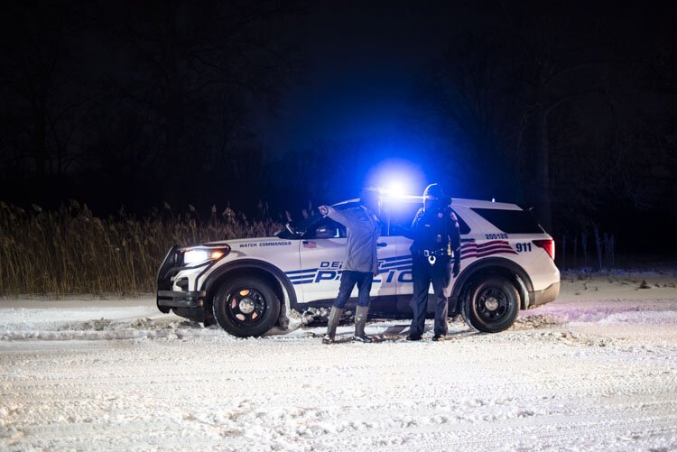 Detroit Sugarbush Project organizer Antonio Cosme speaks with police after a ceremony was disrupted by approximately 14 officers on Feb. 18 at River Rouge Park.