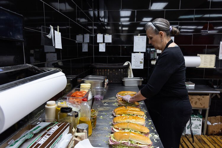 An employee makes sandwiches at Ventimiglia's.
