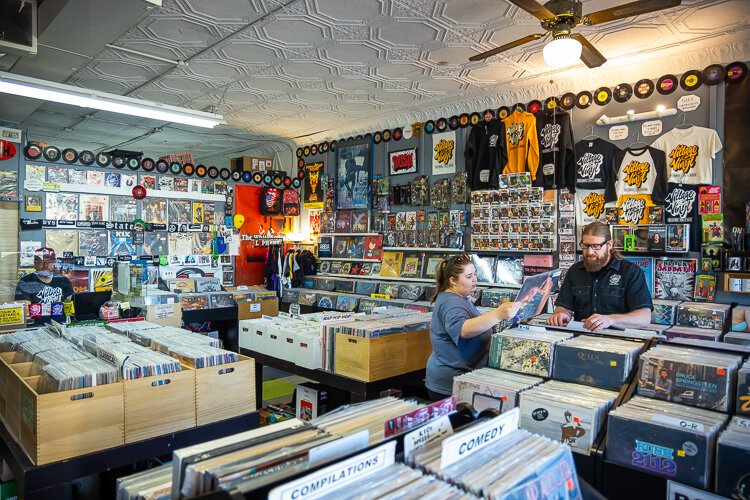 Village Vinyl owner John Lehl helps a customer.