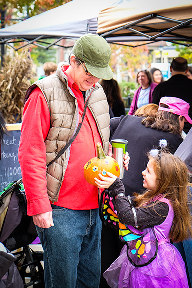 Daughter Shows Off Her Decorated Pumpkin at the Farmington Pavilion