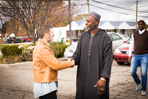 Macomb Muslims gather in front of a mosque before a prayer service