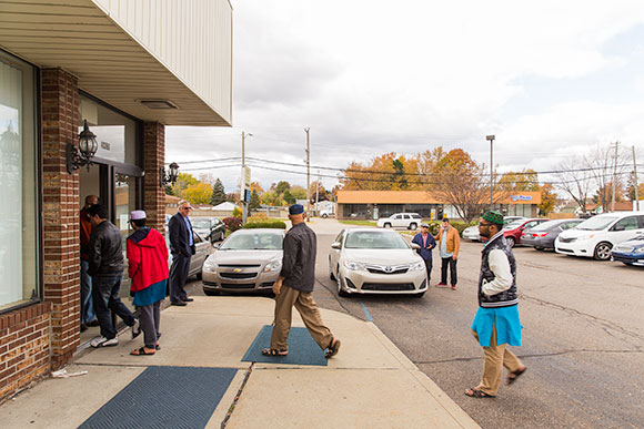 Macomb Muslims gather in front of a mosque before a prayer service