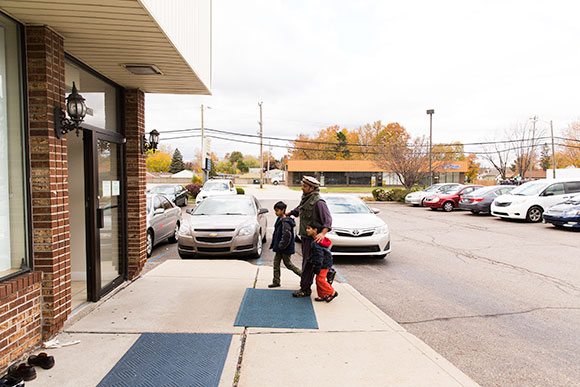 Macomb Muslims gather in front of a mosque before a prayer service